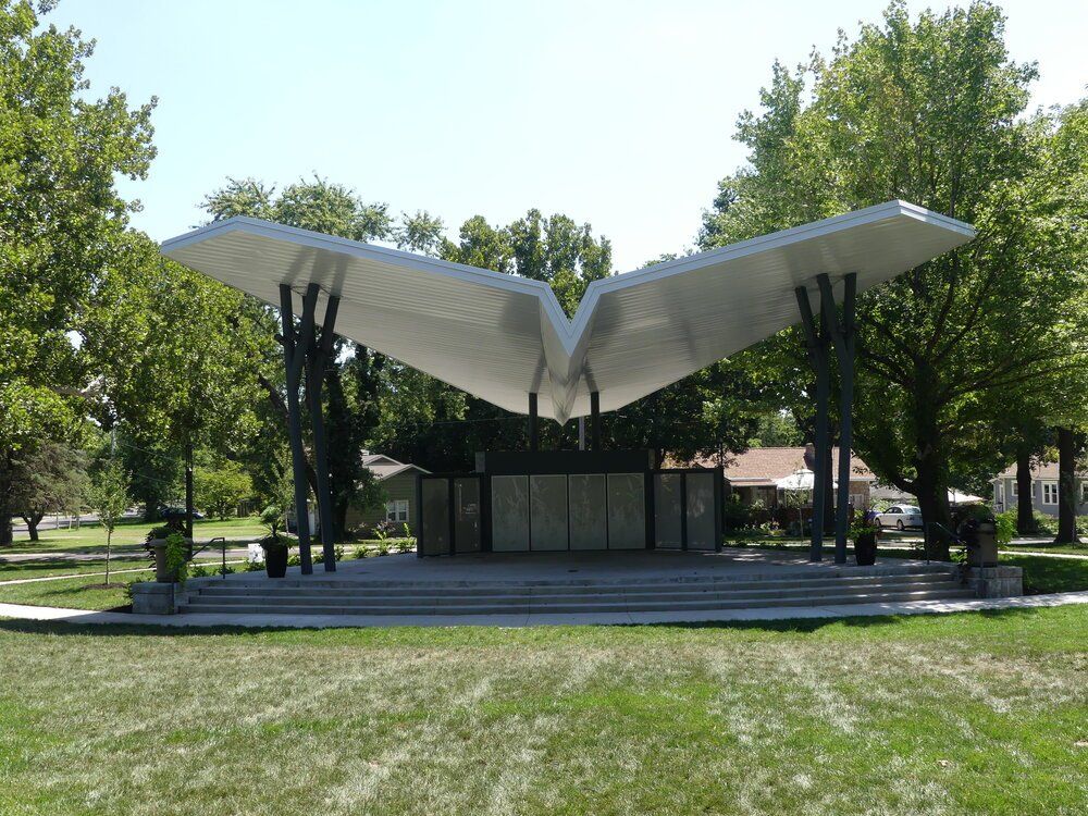 A stage in a park with trees in the background