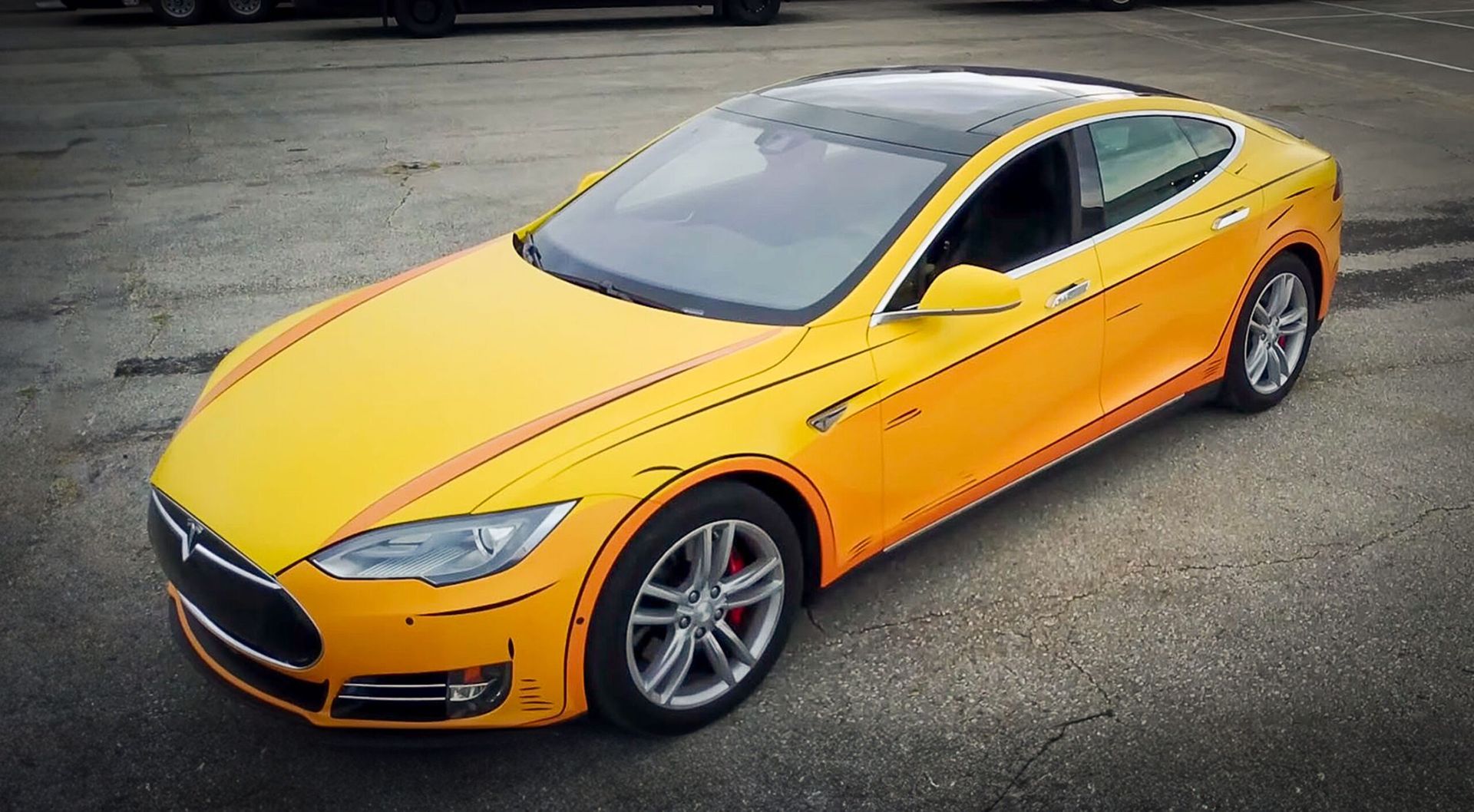 Yellow sports sedan parked on pavement, viewed from above at a slight angle.