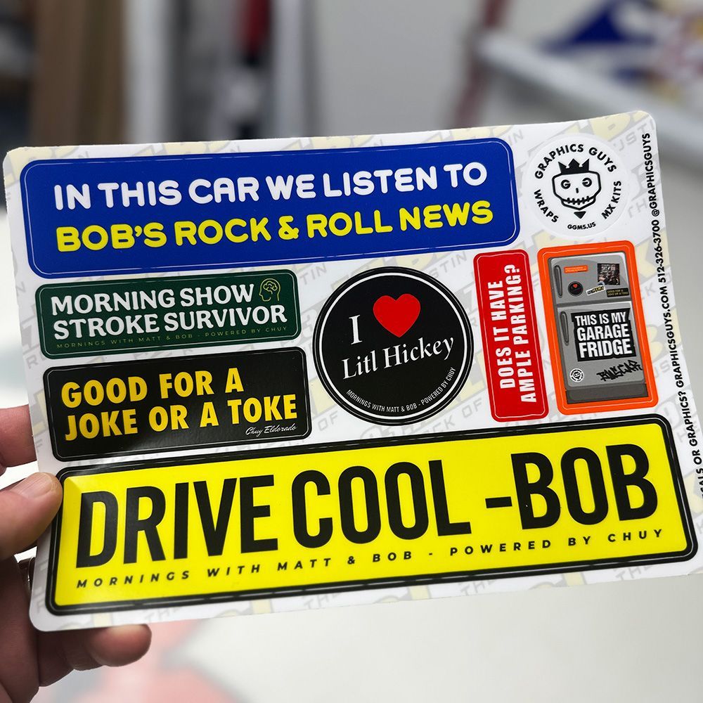 Sticker-covered card promoting Bob’s Rock & Roll News, with bold yellow “DRIVE COOL-BOB” banner.