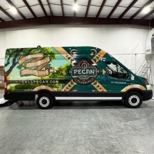 Branded PECAN delivery van in a warehouse, with green and tan graphics and “GulfPecan.com” on the side