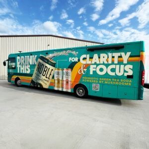 Teal beverage truck with bold “Drink This” and “Clarity & Focus” text parked outdoors