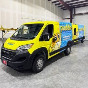 Yellow and blue Puddle-branded delivery van parked indoors in a warehouse
