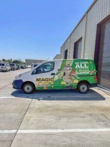Green Magic van parked outside a warehouse on a sunny day