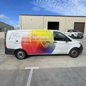 White van with colorful “Captivate” logo parked outside an industrial building