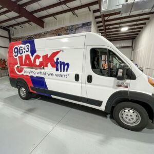 White 96.3 JACK FM promo van parked indoors in a warehouse-like space