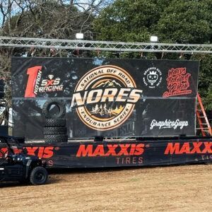NORDS off-road racing banner with MAXXIS logos at a dirt track