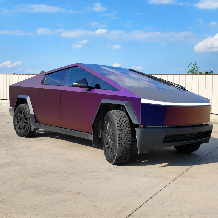 Futuristic purple Tesla Cybertruck parked on a concrete lot under a blue sky.