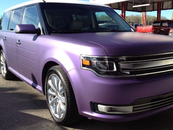 Purple SUV parked outdoors in a lot, front-left view.