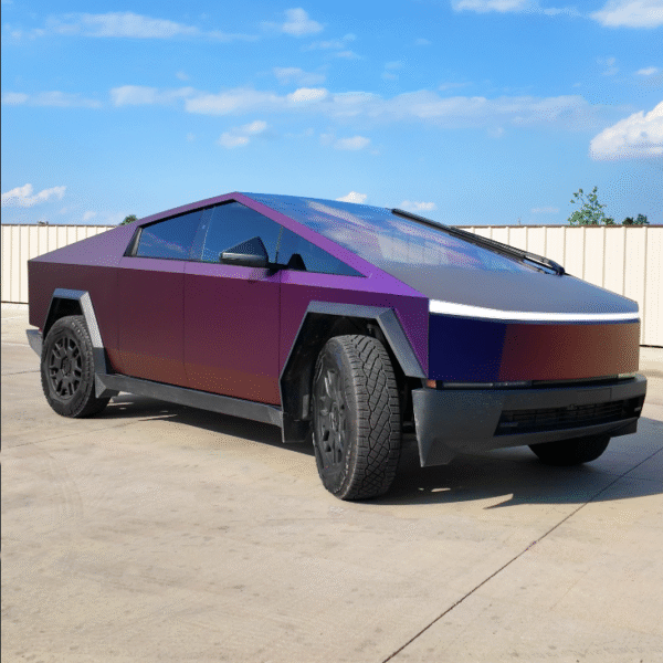 Purple Tesla Cybertruck parked on concrete under a blue sky, viewed from the front left.