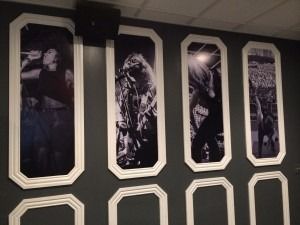 Framed black-and-white portrait panels on a dark wall with gold trim