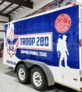 Blue Troop 280 Boy Scout trailer with eagle logo, white silhouette, and “Draping Springs, Texas” text.