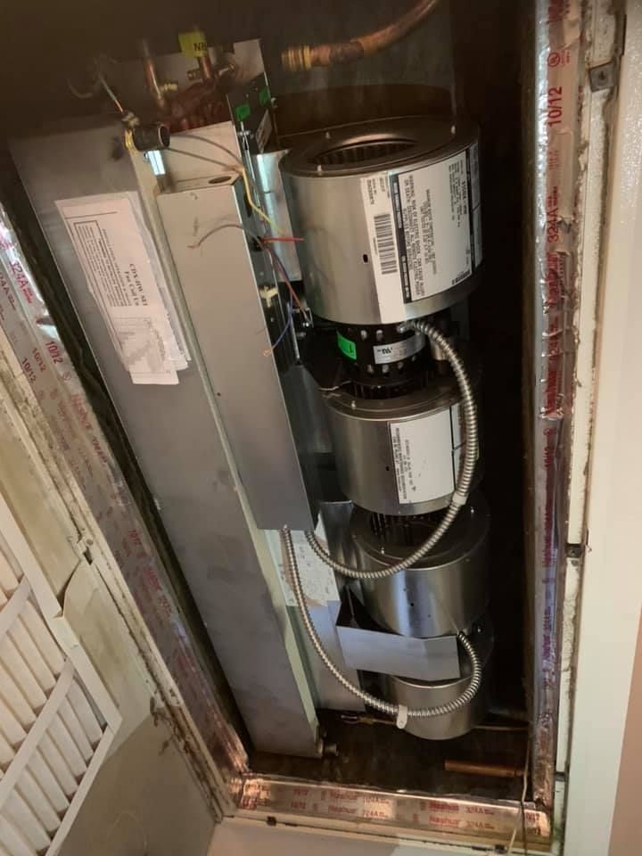 HVAC system with multiple blower motors inside a duct. Wires and labels are visible.