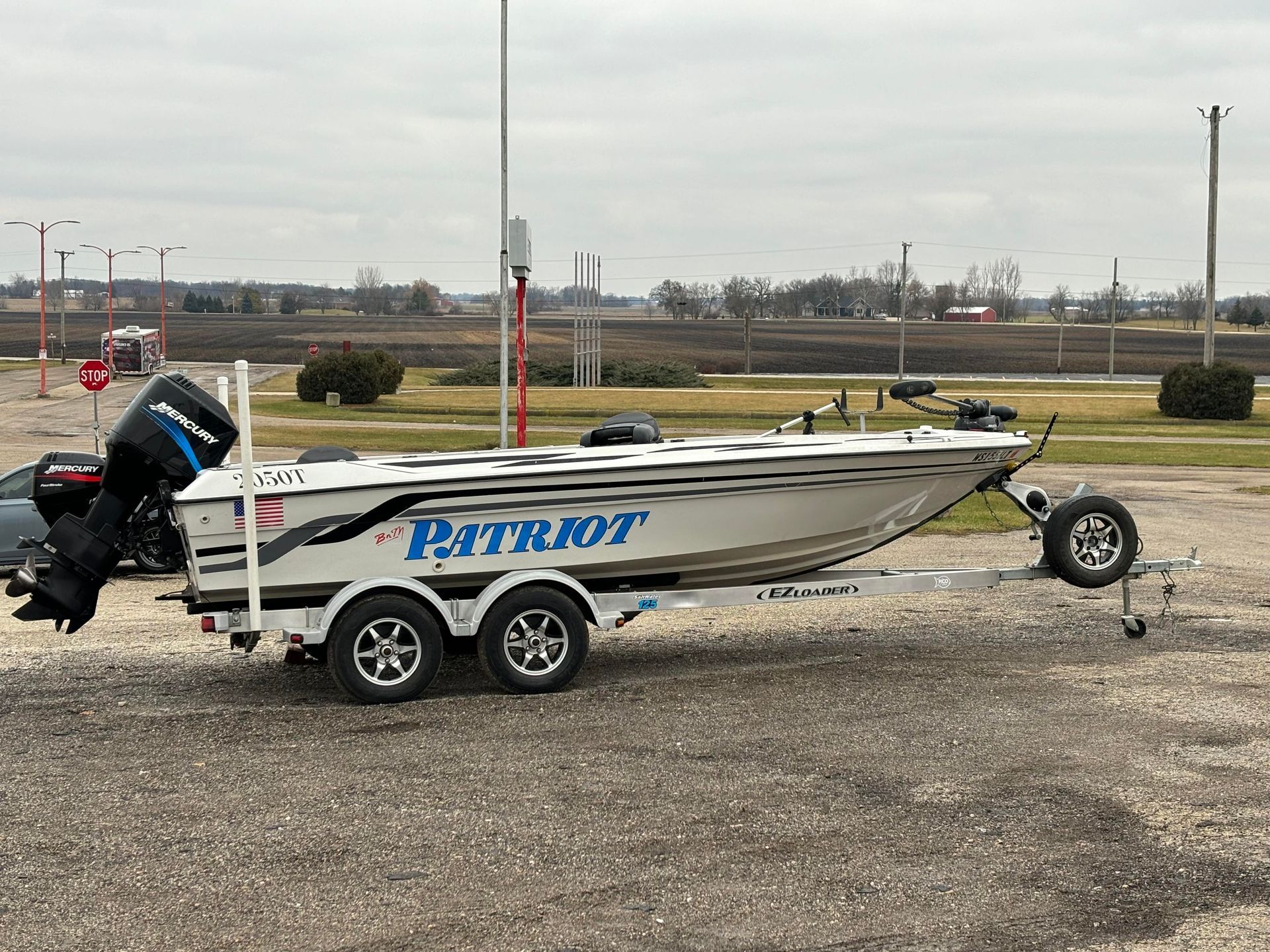 a boat is parked on a trailer in a parking lot