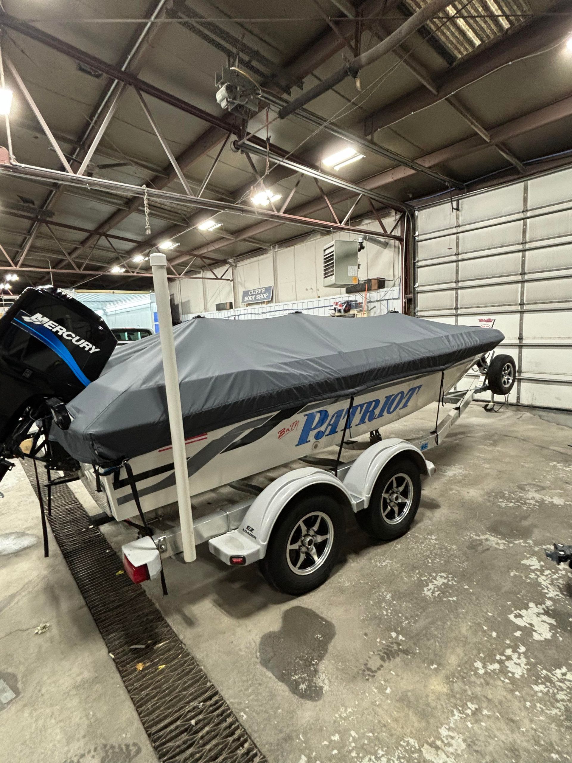 a boat with a cover on it is parked in a garage