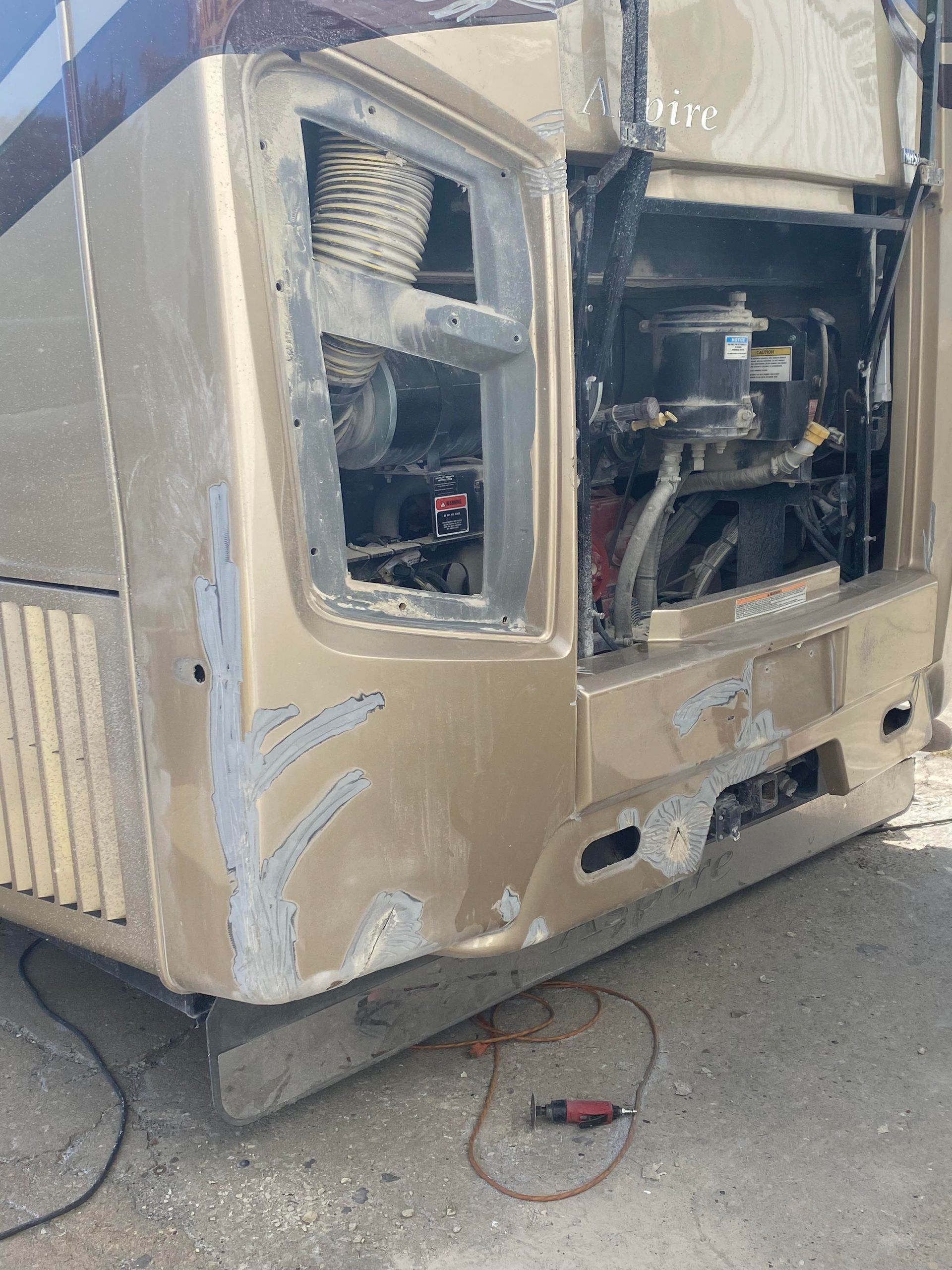 a rv with its hood open is sitting on the side of the road