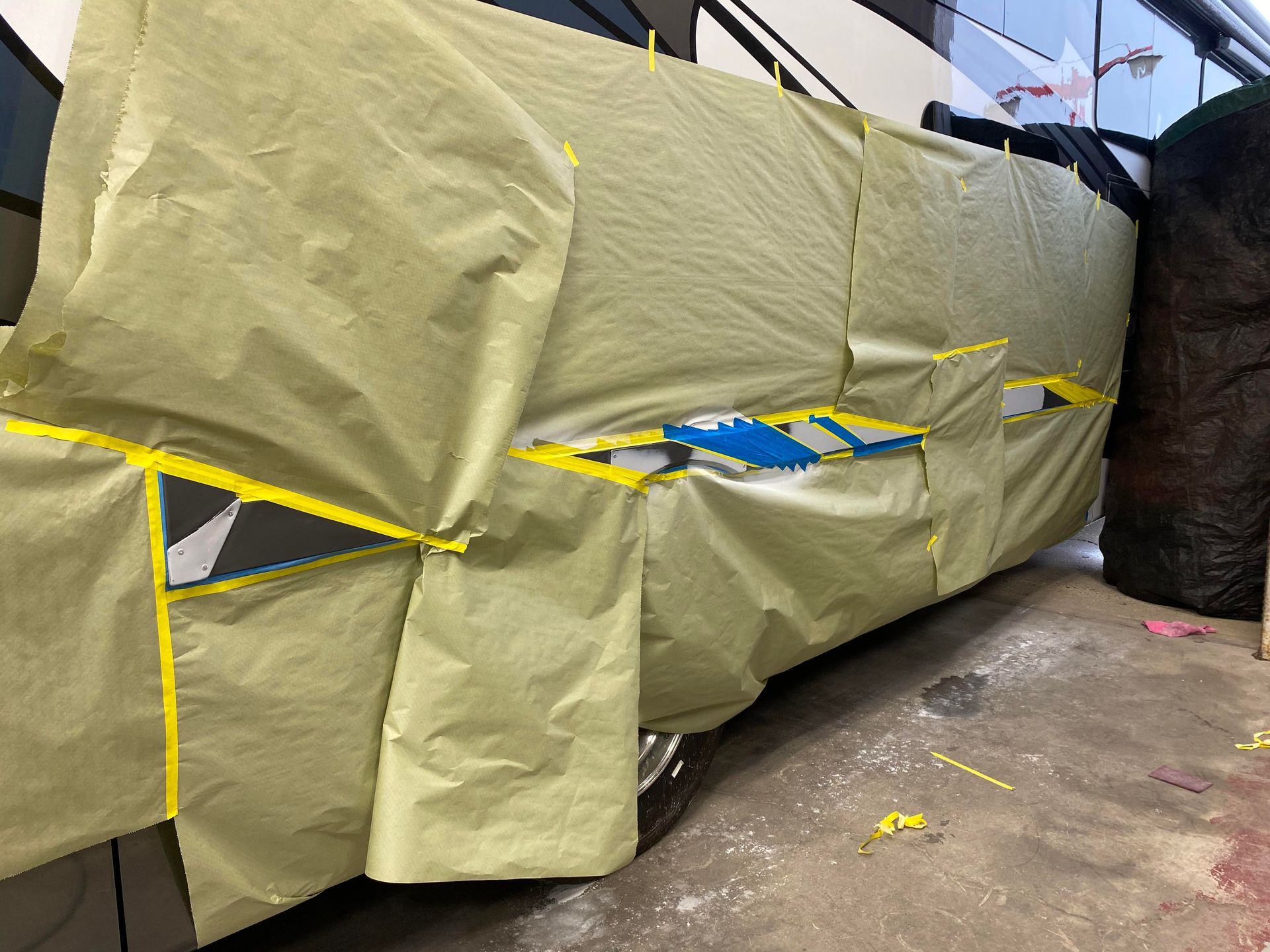 a large piece of yellow tarp is covering a vehicle