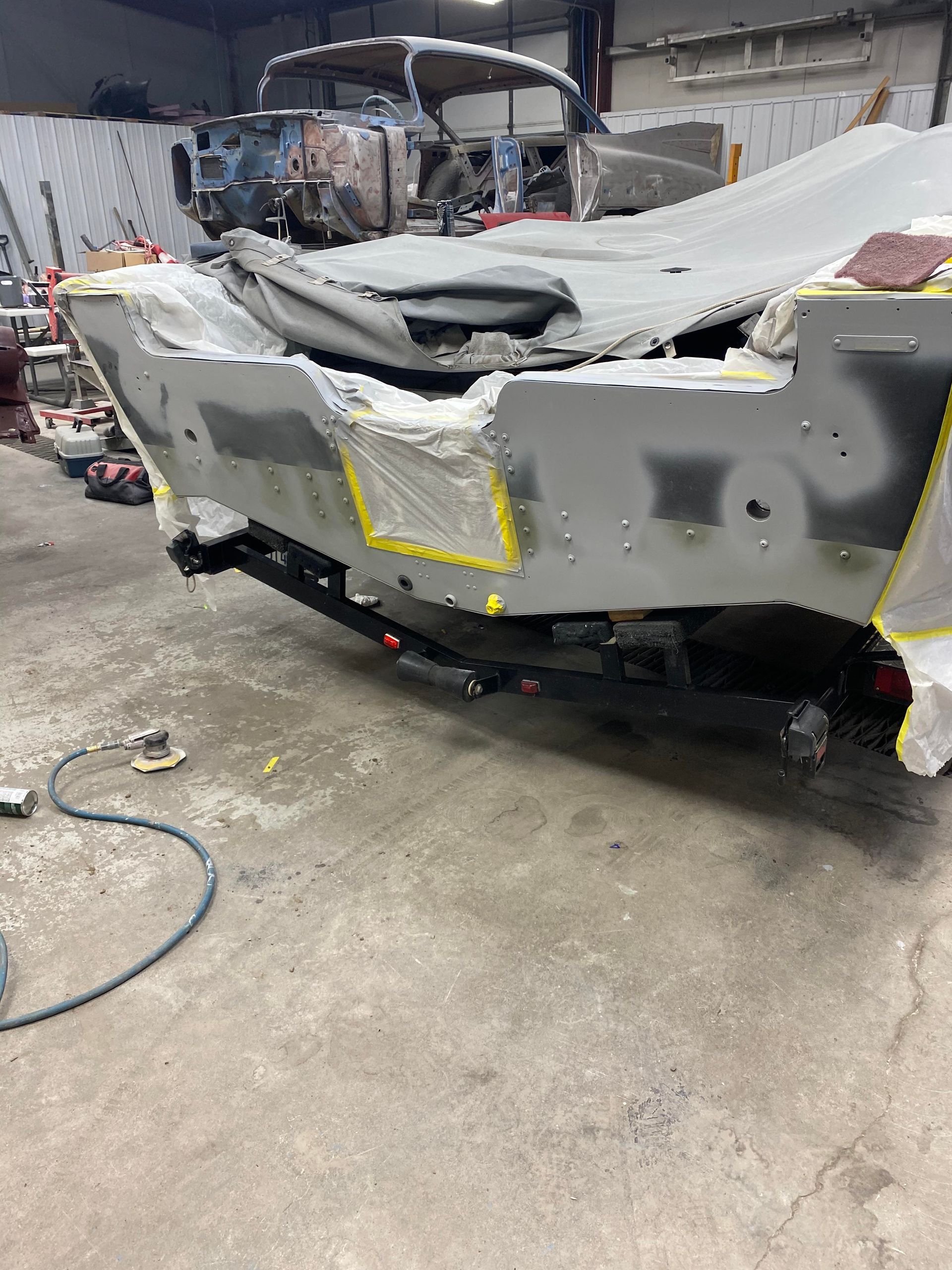 a boat is being painted in a garage