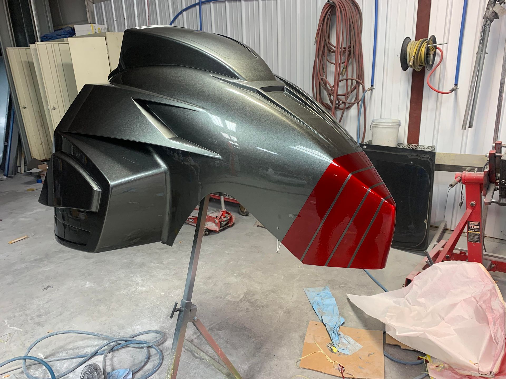 a gray and red object is sitting on a table in a garage