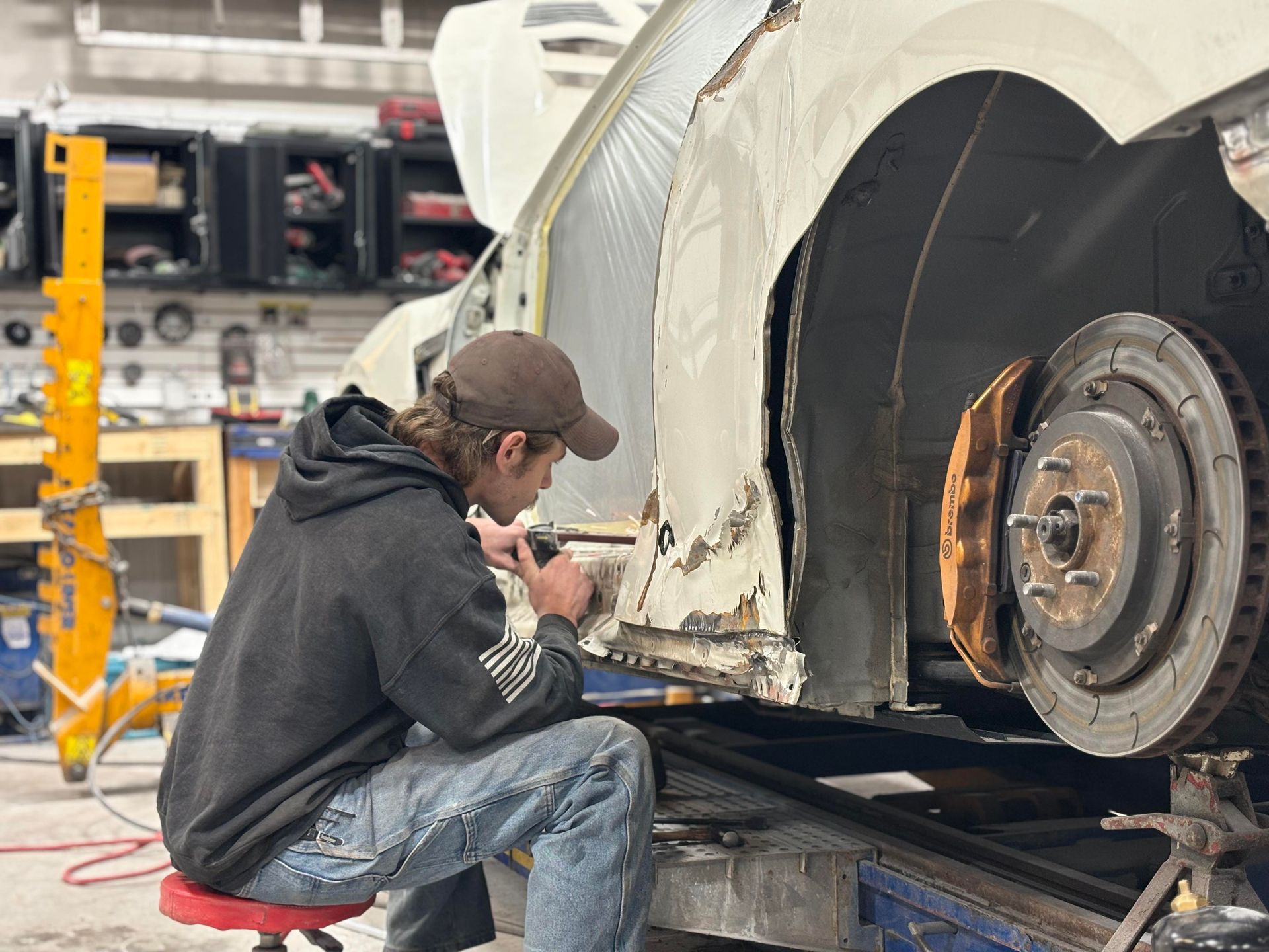 a man is working on a car in a garage