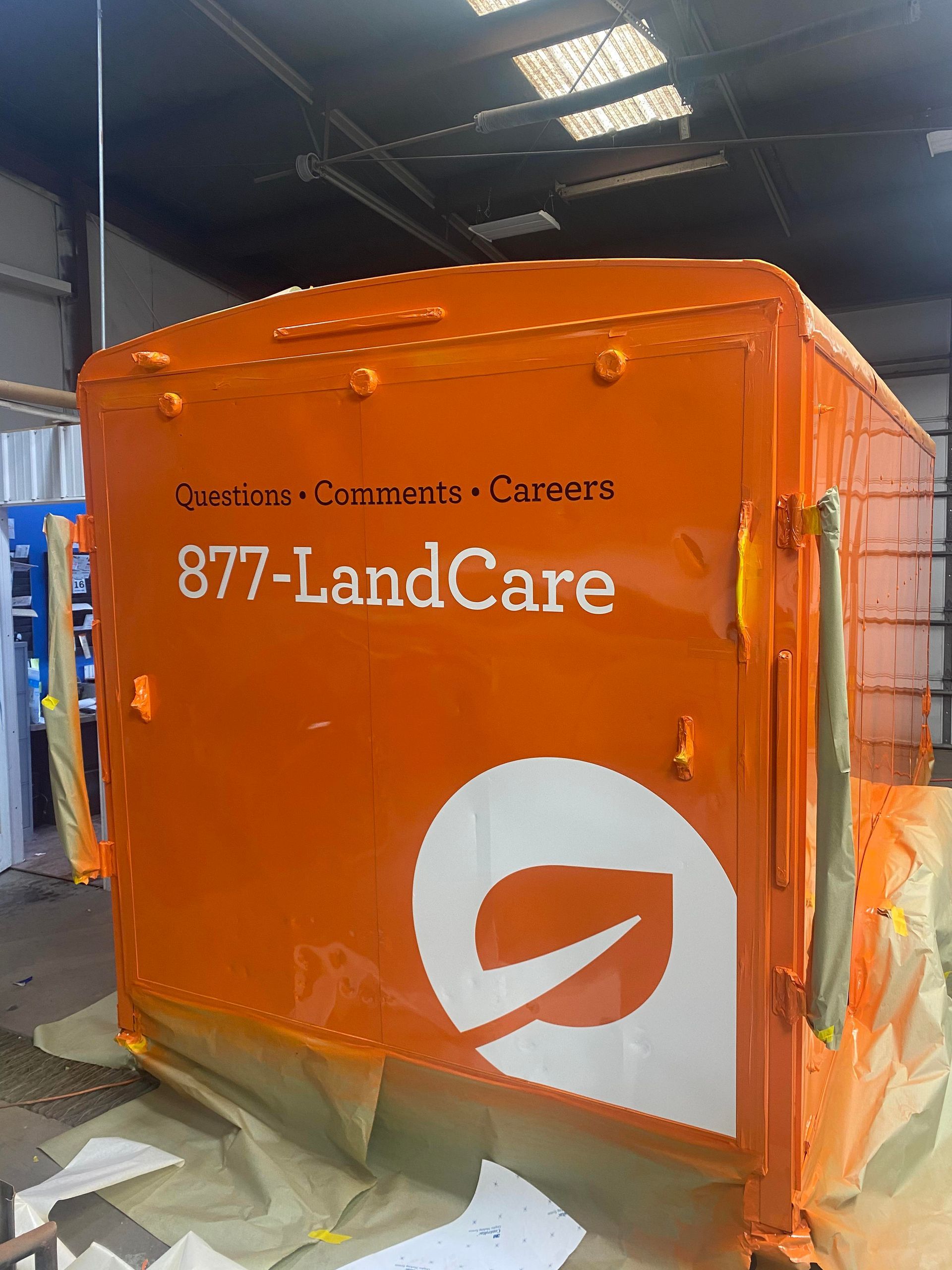 a large orange box with the words 877-landcare written on it