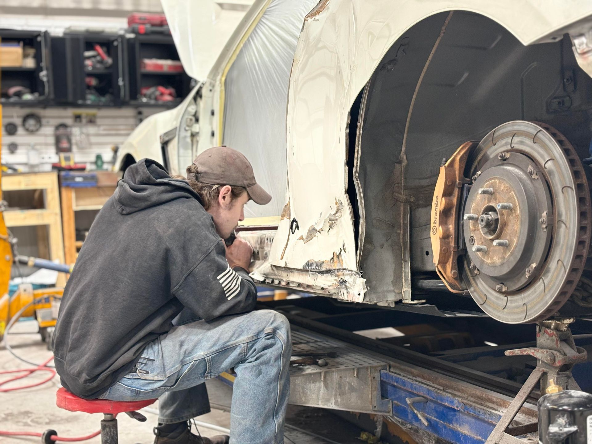 a man is working on a car in a garage
