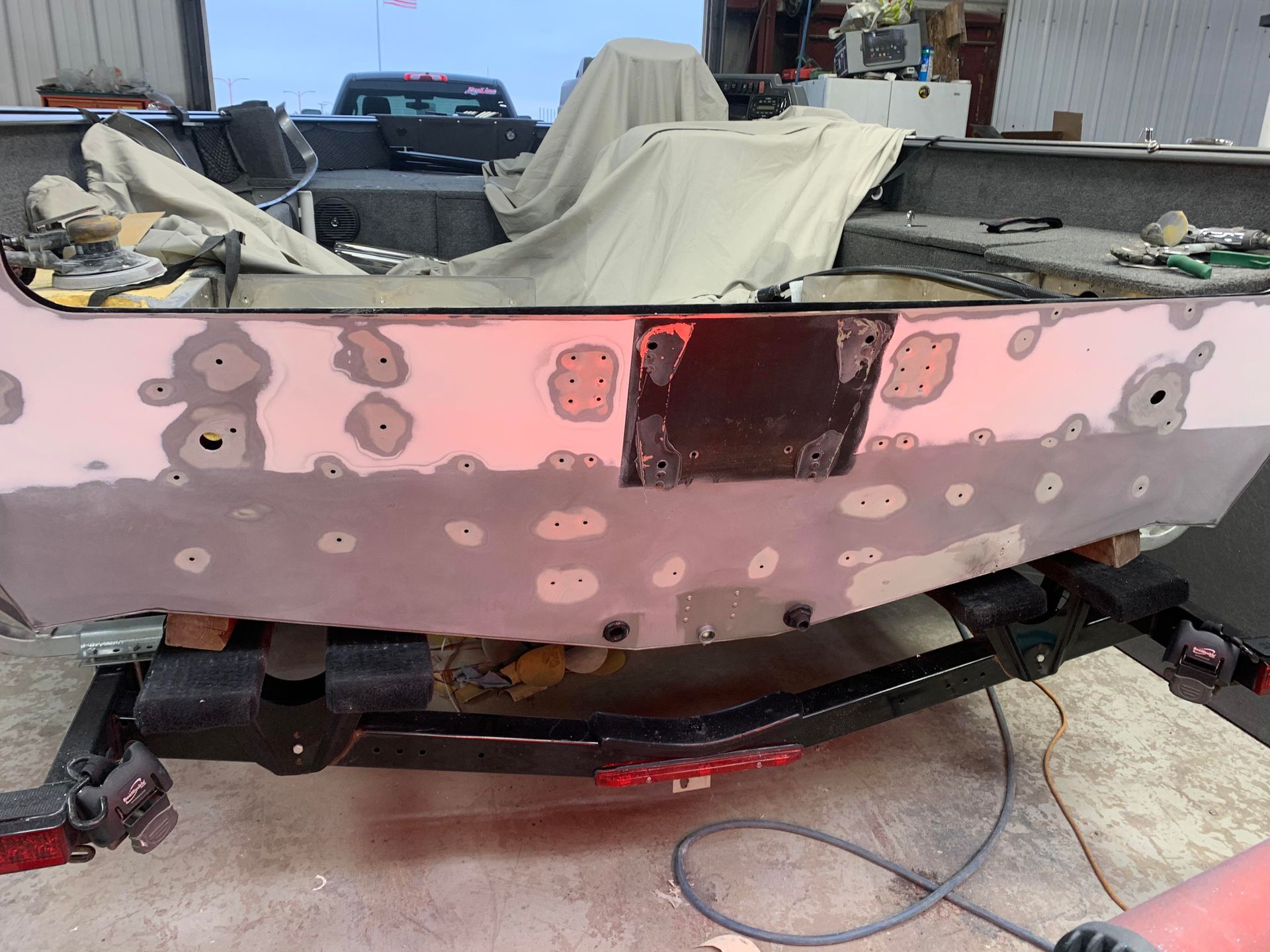 a boat is being painted in a garage