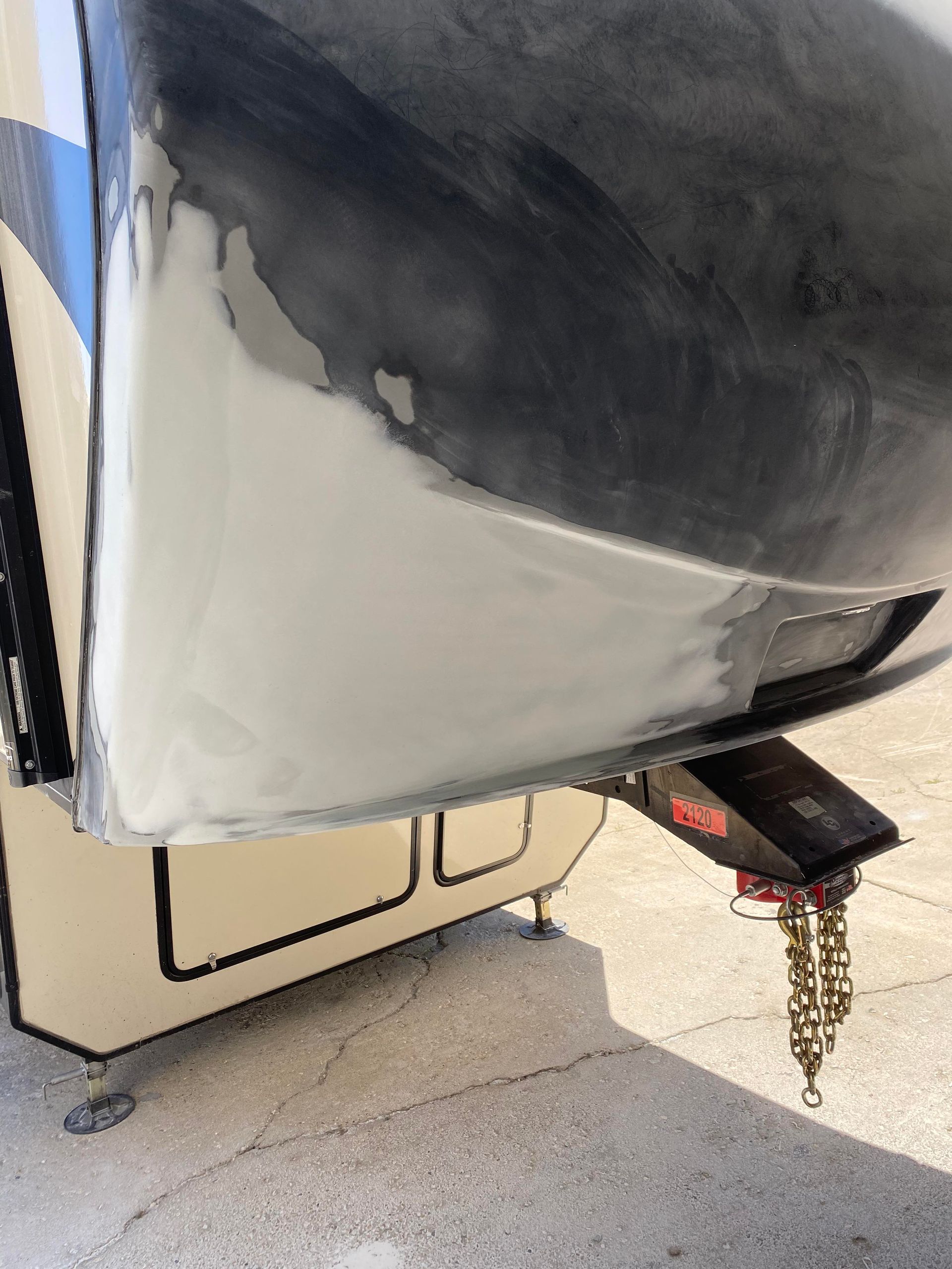 a boat with a trailer attached to it is sitting on the ground