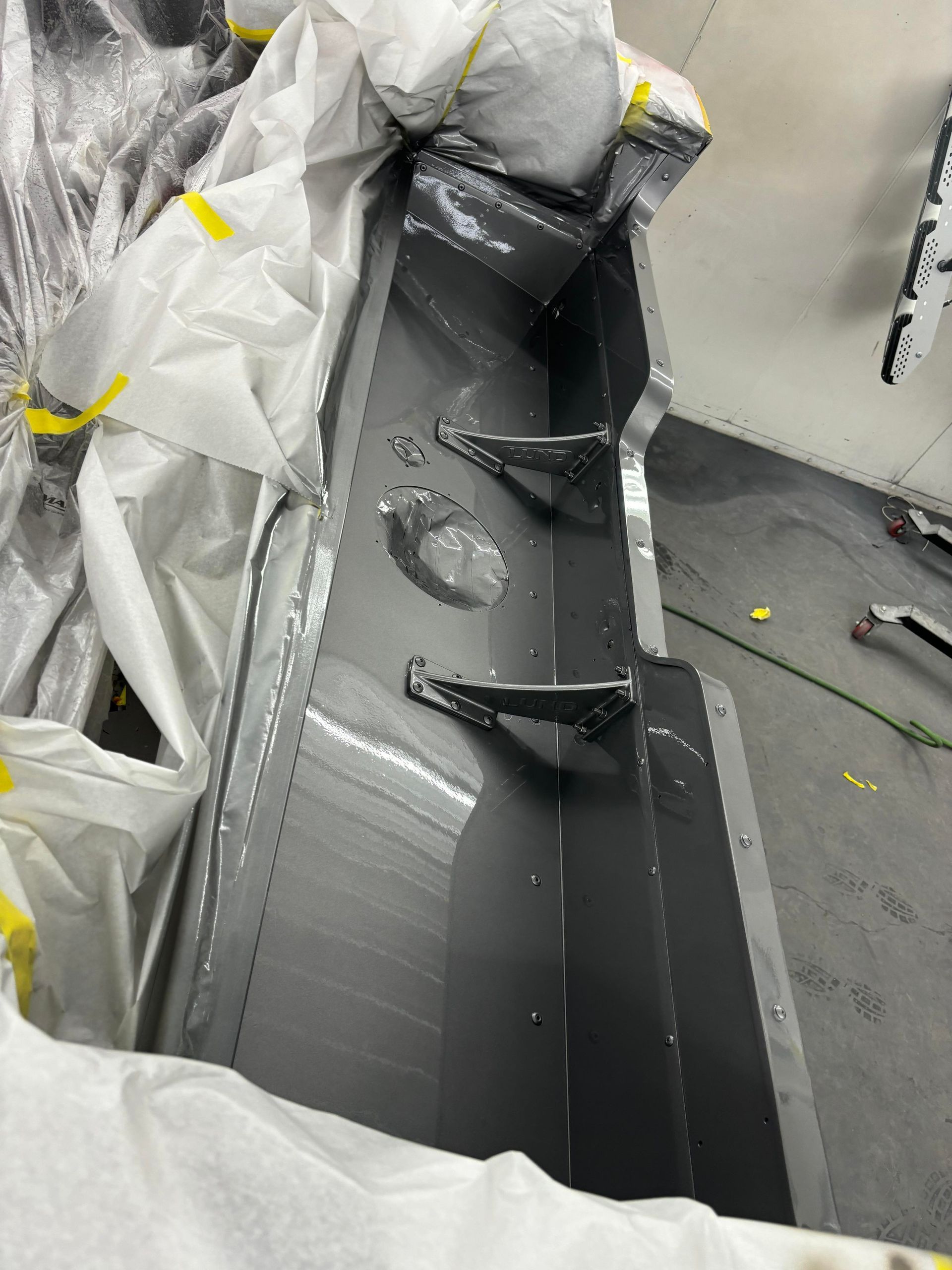 a large piece of metal is being painted in a garage