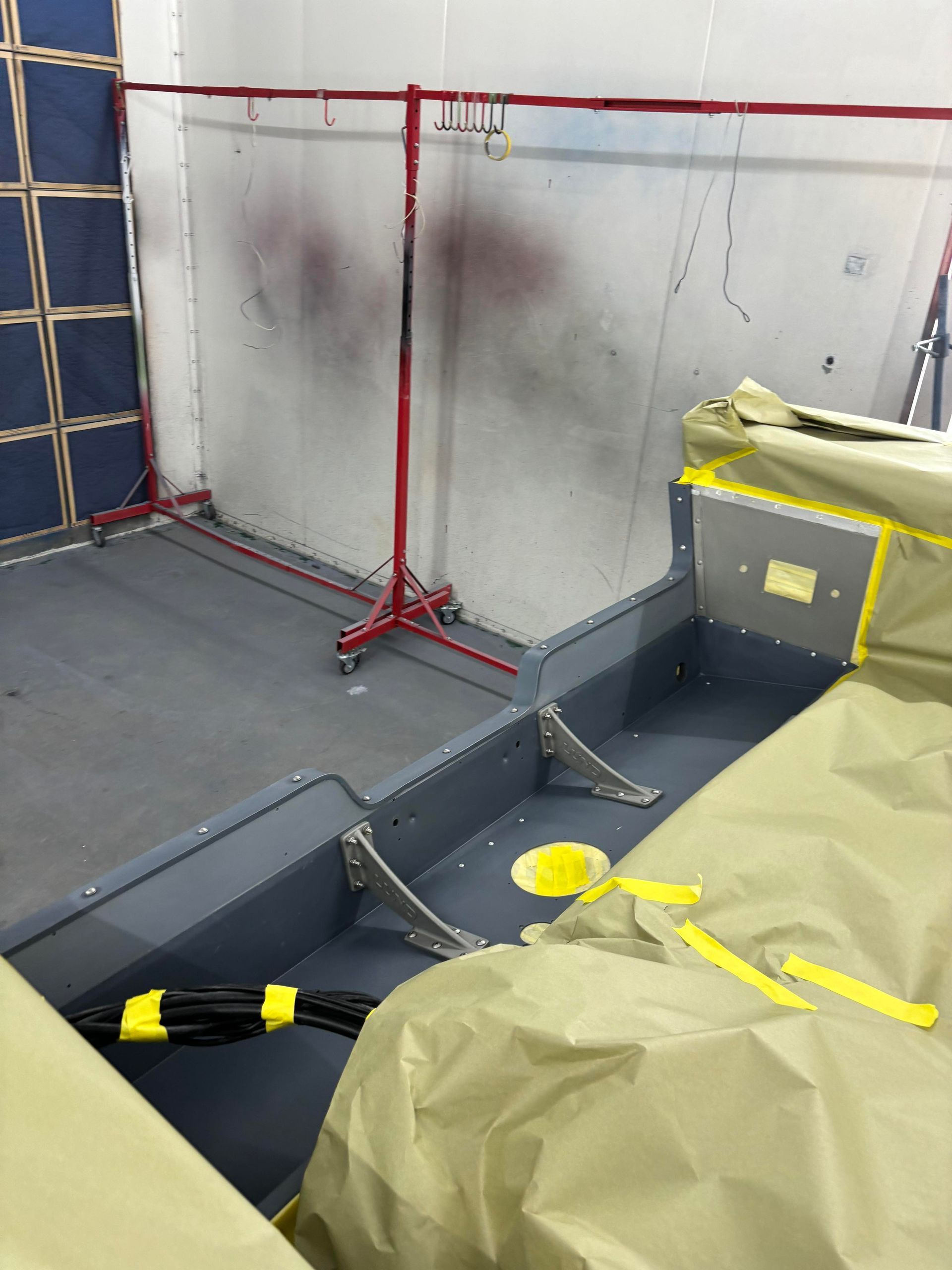 a room with a ladder and a table with yellow tape on it