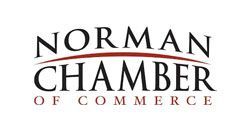 Norman Chamber of Commerce logo with black text on a white background, red curved line above