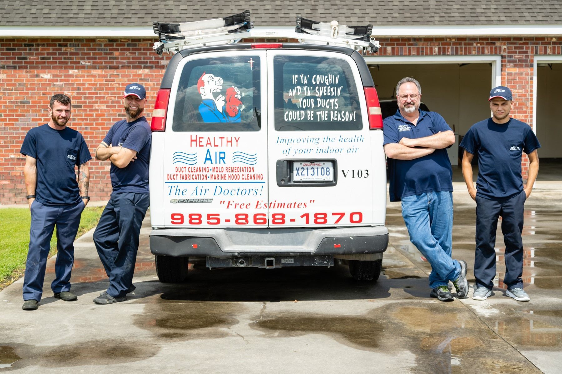 A group of men are standing in front of a van.