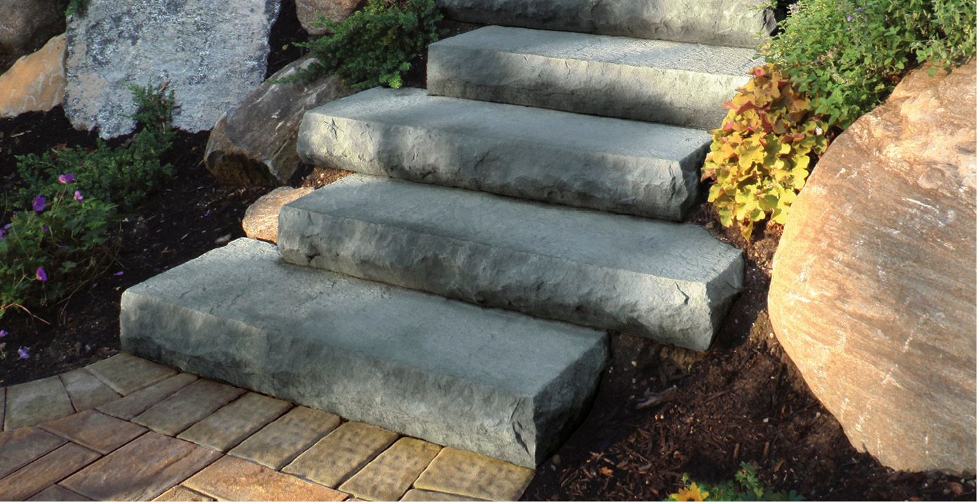 A set of stone stairs leading up to a rocky hillside.