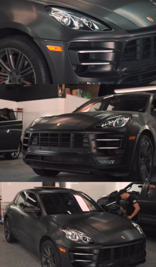 A black Porsche is parked in a garage