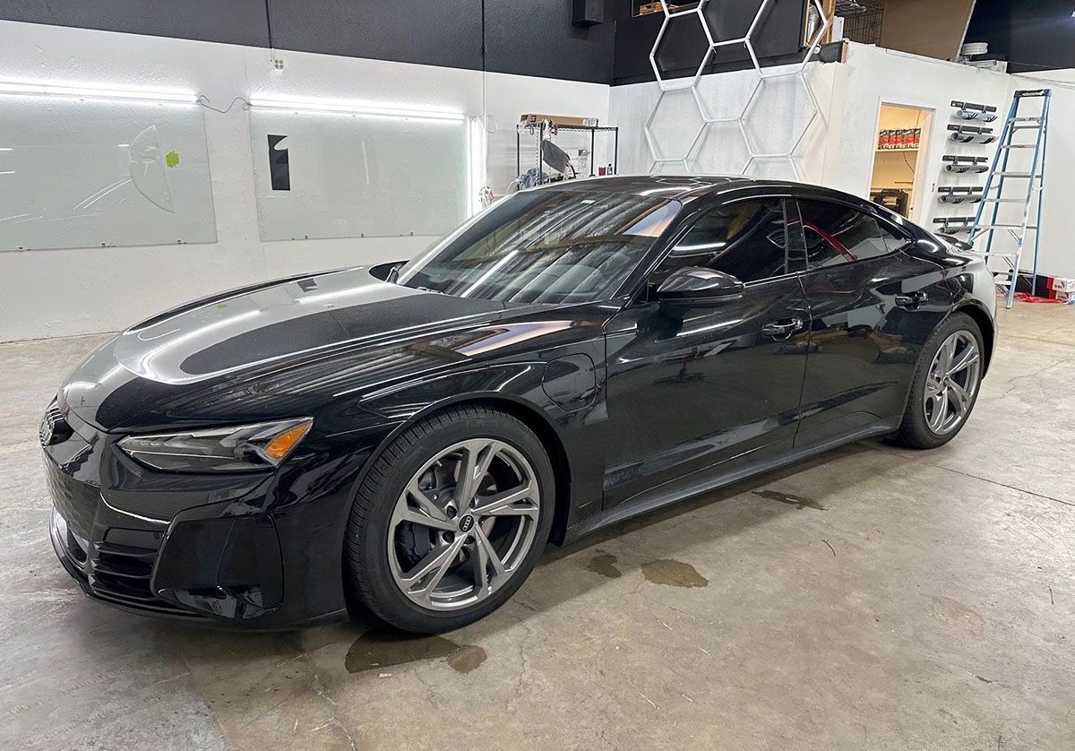 An elegant black car with vinyl wrap