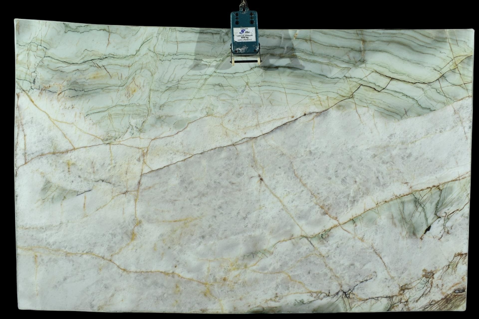 A piece of marble is being measured on a black background