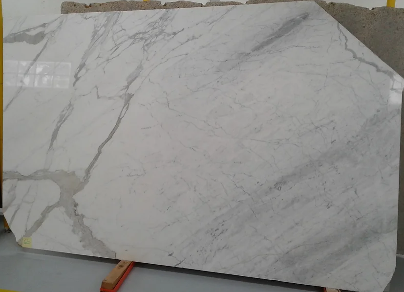 A large white marble slab is sitting on top of a wooden table.