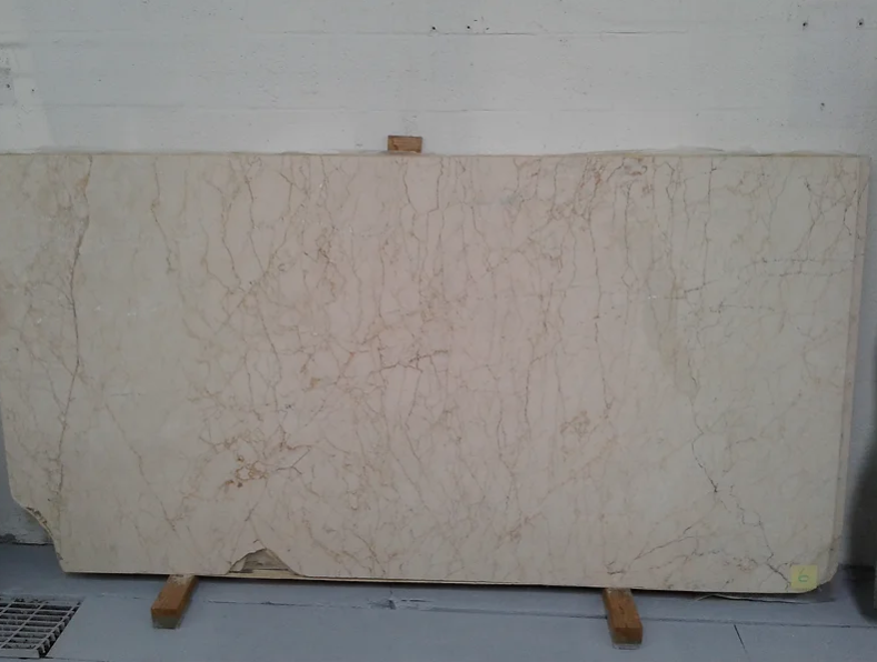 A large white marble slab is sitting on a wooden stand.
