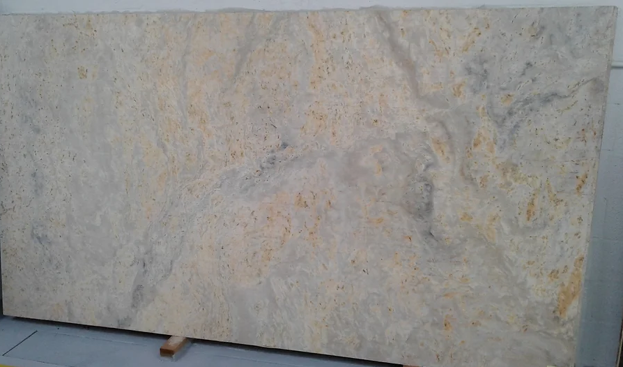 A large white granite slab is sitting on top of a wooden table.