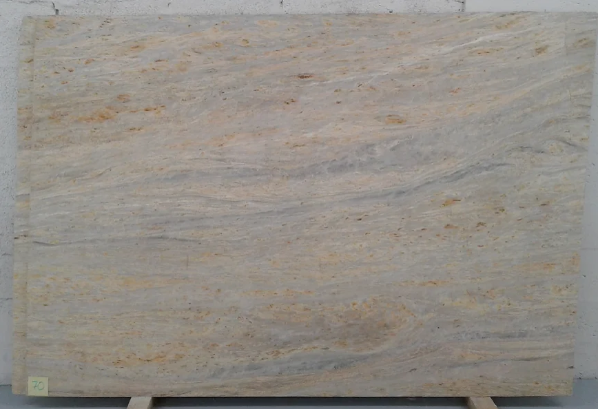 A large piece of marble is sitting on a wooden stand.