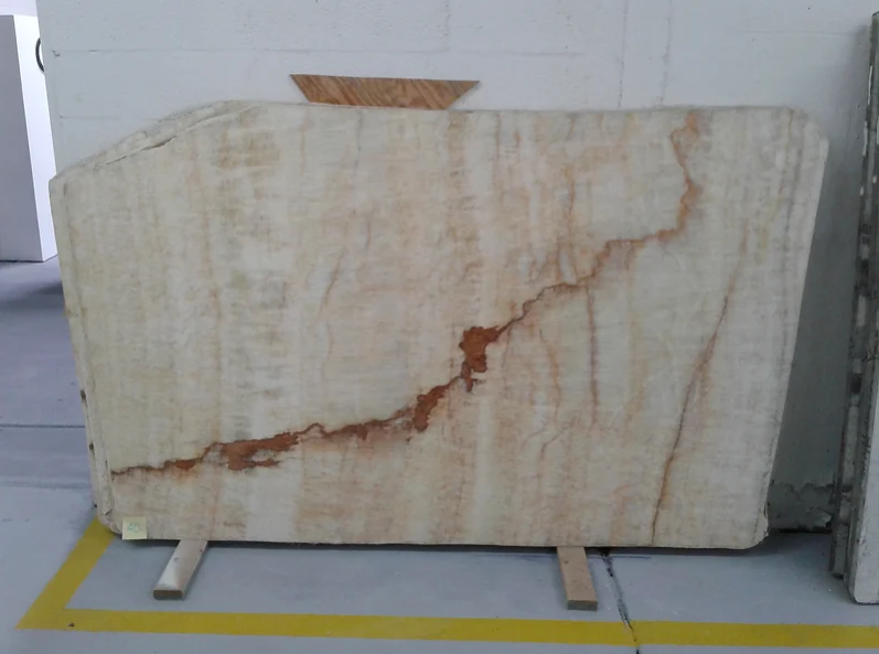 A large piece of marble is sitting on a yellow line