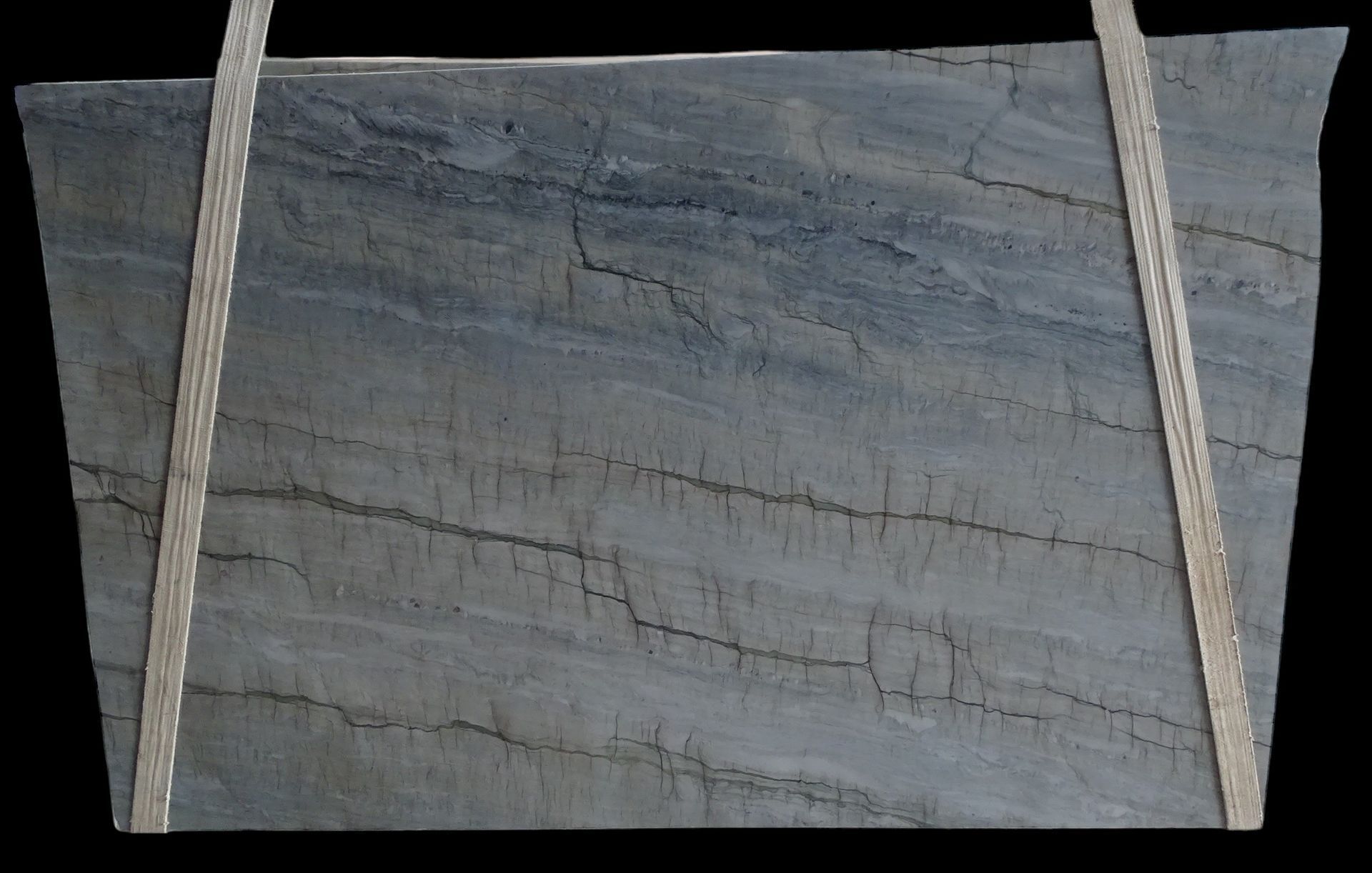 A piece of marble is hanging from a rope on a black background.