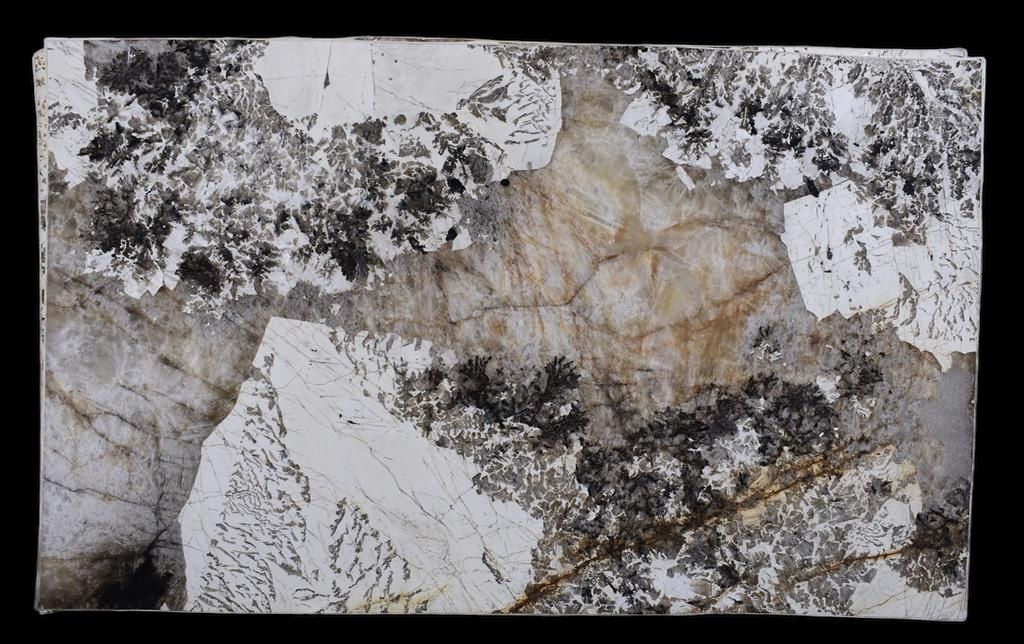 A close up of a piece of marble with a black background