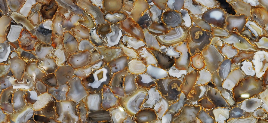 A close up of a marble counter top with a lot of stones on it.