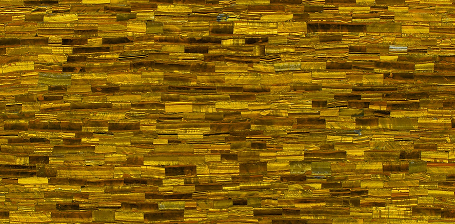 A close up of a yellow brick wall.