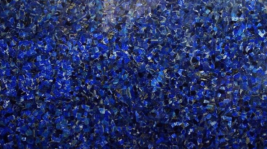 A close up of a blue marble texture with a lot of small blue stones.