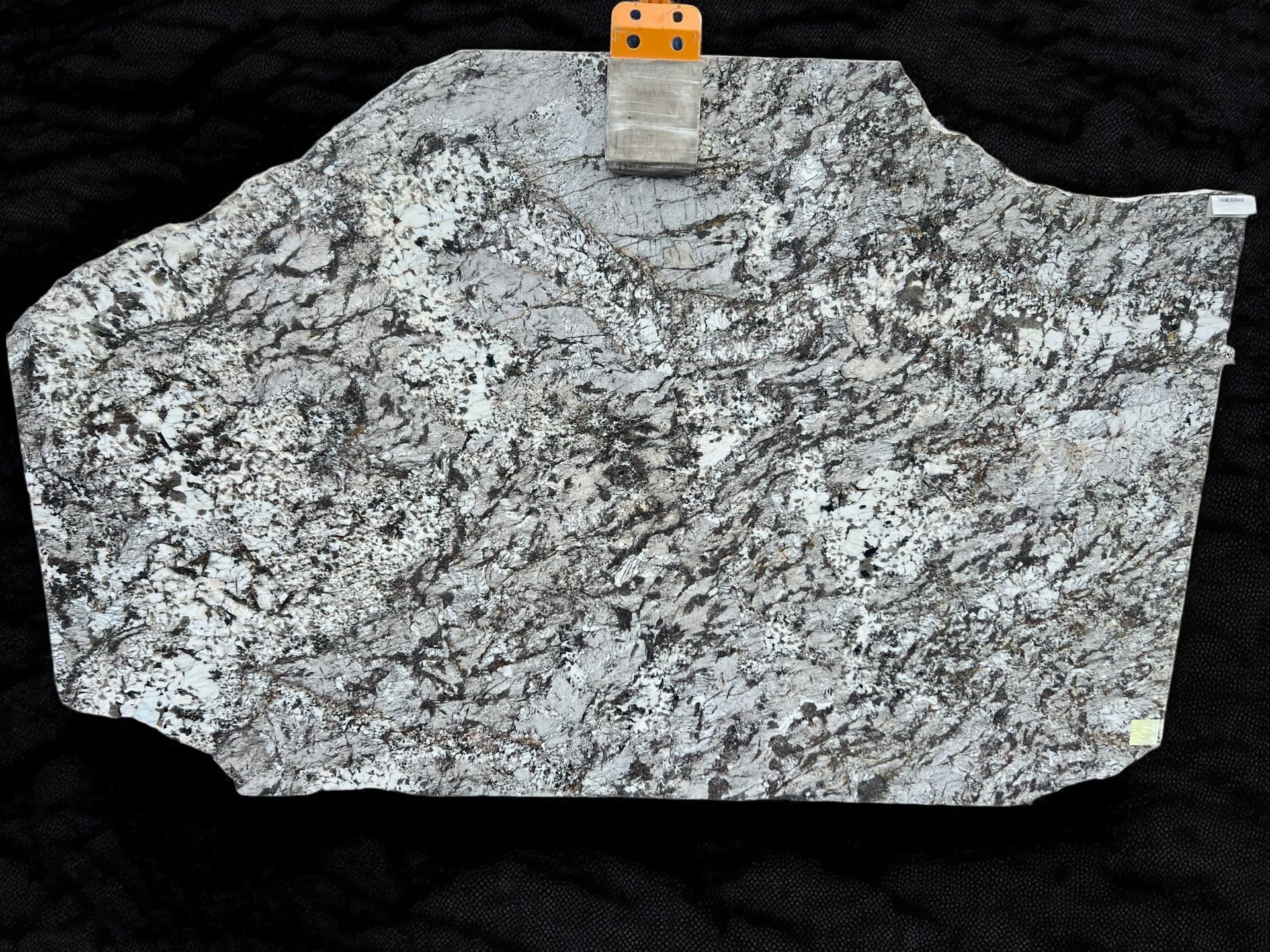 A piece of granite is sitting on a black surface