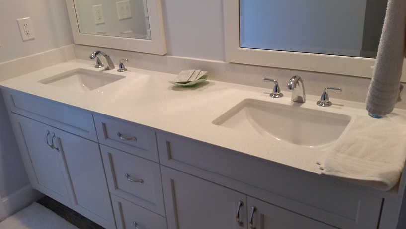 A bathroom with two sinks and two mirrors.