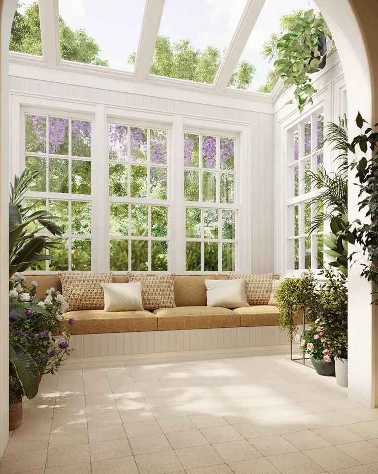 There is a couch in the middle of the room with a lot of windows