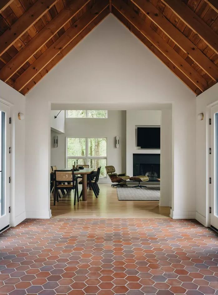 A house with a vaulted ceiling and a brick floor
