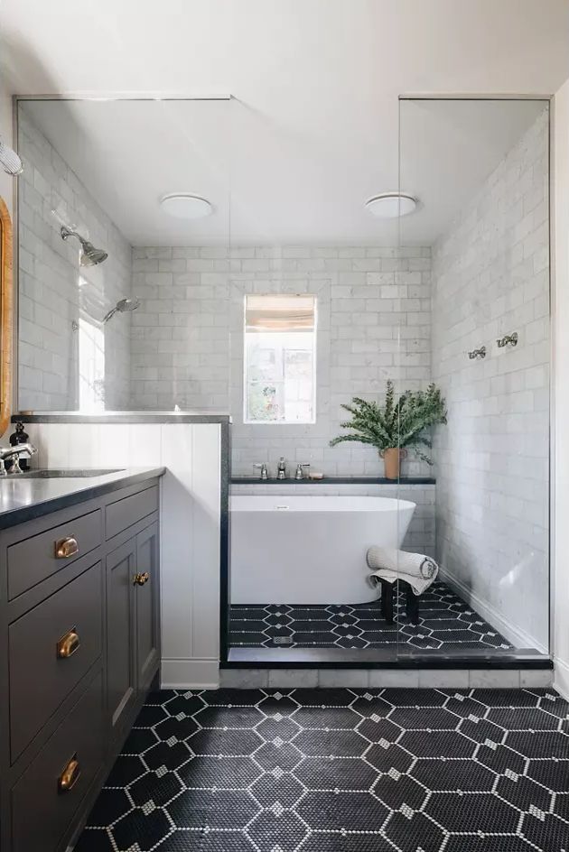 A bathroom with a tub, sink, and shower